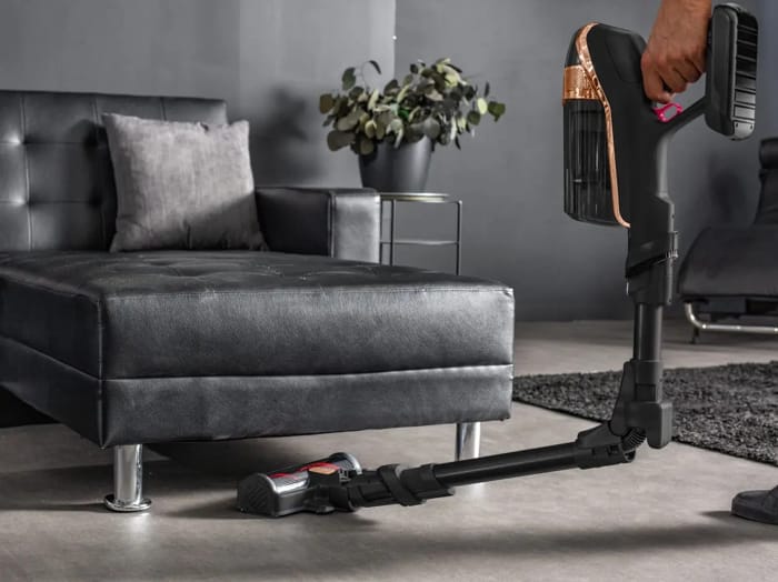 Aspirator fără sac Rowenta X-Force Flex 15.60 în acțiune sub canapea modernă