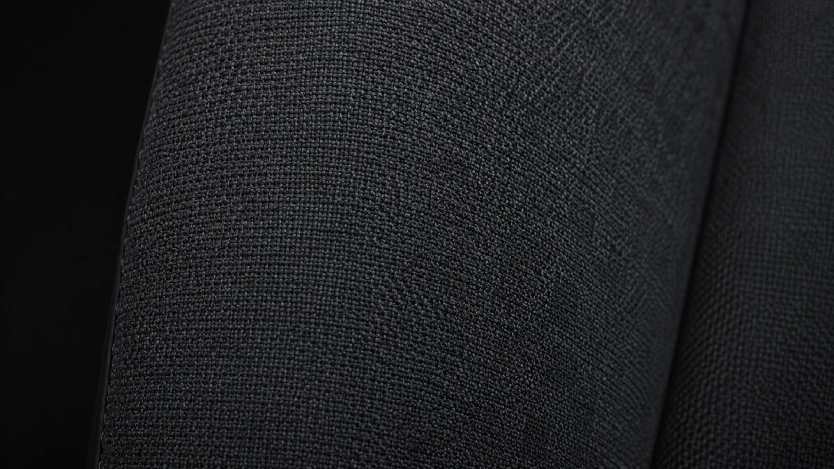 Detaliu tapițerie textil scaun gaming — țesătură charcoal respirabilă în prim-plan